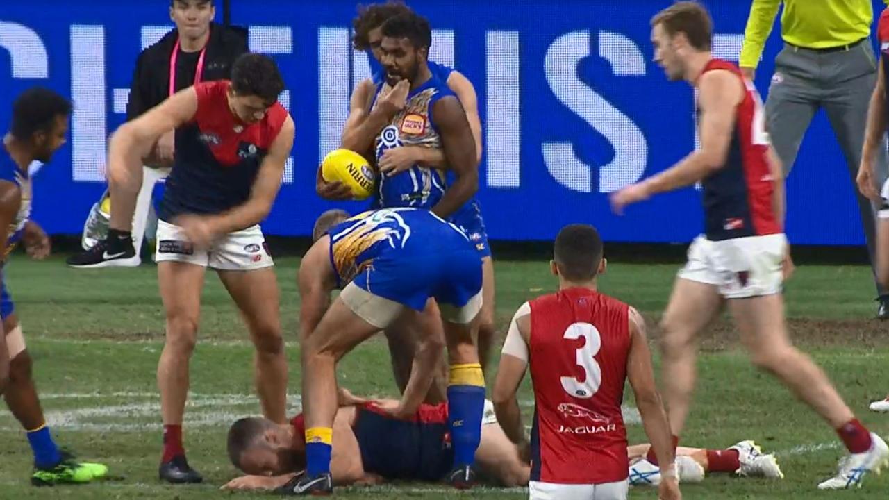 Nathan Vardy pushes a prone Max Gawn.