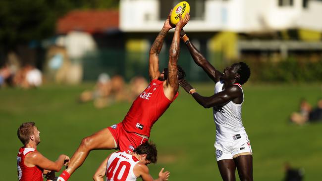 Aliir Aliir attempts to spoil Lance Franklin during a Sydney practice match. Picture: Brett Costello