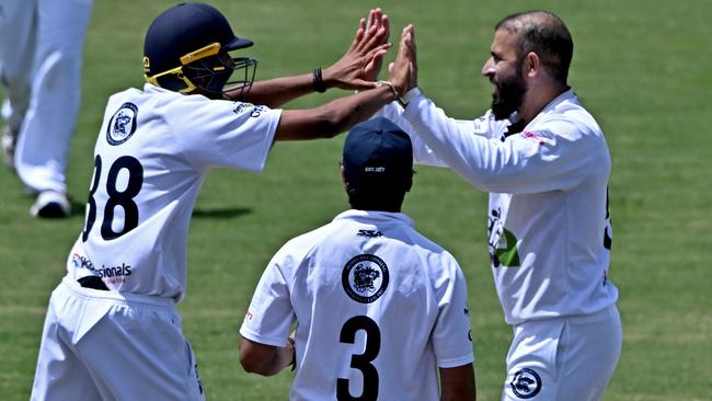 Fawad Ahmed (right) celebrates a wicket for Hoppers Crossing. Picture: Andy Brownbill