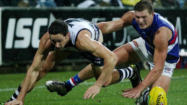 Redpath battles with Geelong defender Harry Taylor on debut against the Cats. Picture: Colleen Petch.