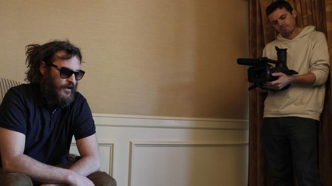 Casey Affleck, right, filming his brother-in-law, Joaquin Phoenix, on the set of I’m Still Here. Picture: AP