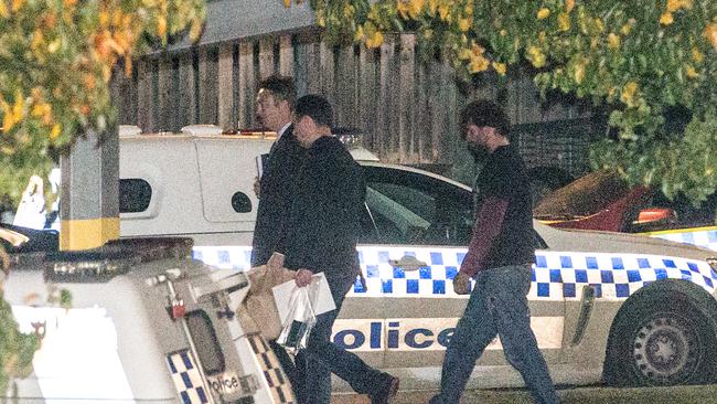 Christian Bain-Singh (right) is walked from the Cranbourne police station.