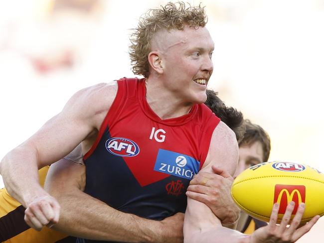 MELBOURNE, AUSTRALIA - MARCH 23: Clayton Oliver of the Demons handballs during the round two AFL match between Hawthorn Hawks and Melbourne Demons at Melbourne Cricket Ground, on March 23, 2024, in Melbourne, Australia. (Photo by Darrian Traynor/Getty Images)