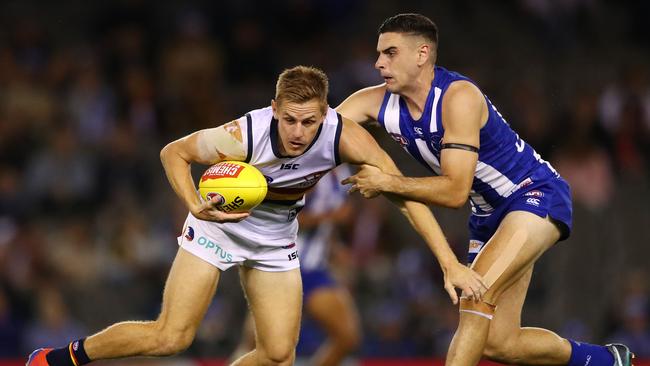 Crow David Mackay gets wrapped up by Paul Ahern of the Kangaroos on Saturday night. Picture: Scott Barbour/Getty Images)