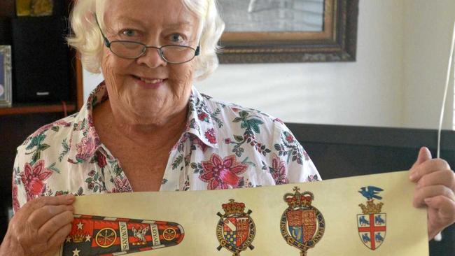 Lady Patricia Yocklunn with her late husband Sir John&#39;s coat of arms in front of a photo taken during her ballerina days. Picture: Jann Houley