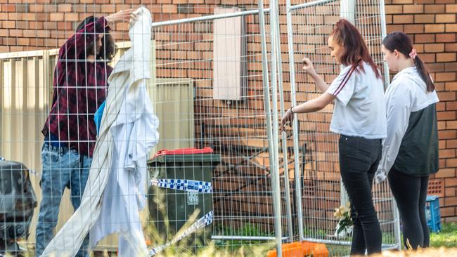 Emotional relatives of victim of Cameron Robert Johnson at the scene of the fire yesterday. Picture: Monique Harmer