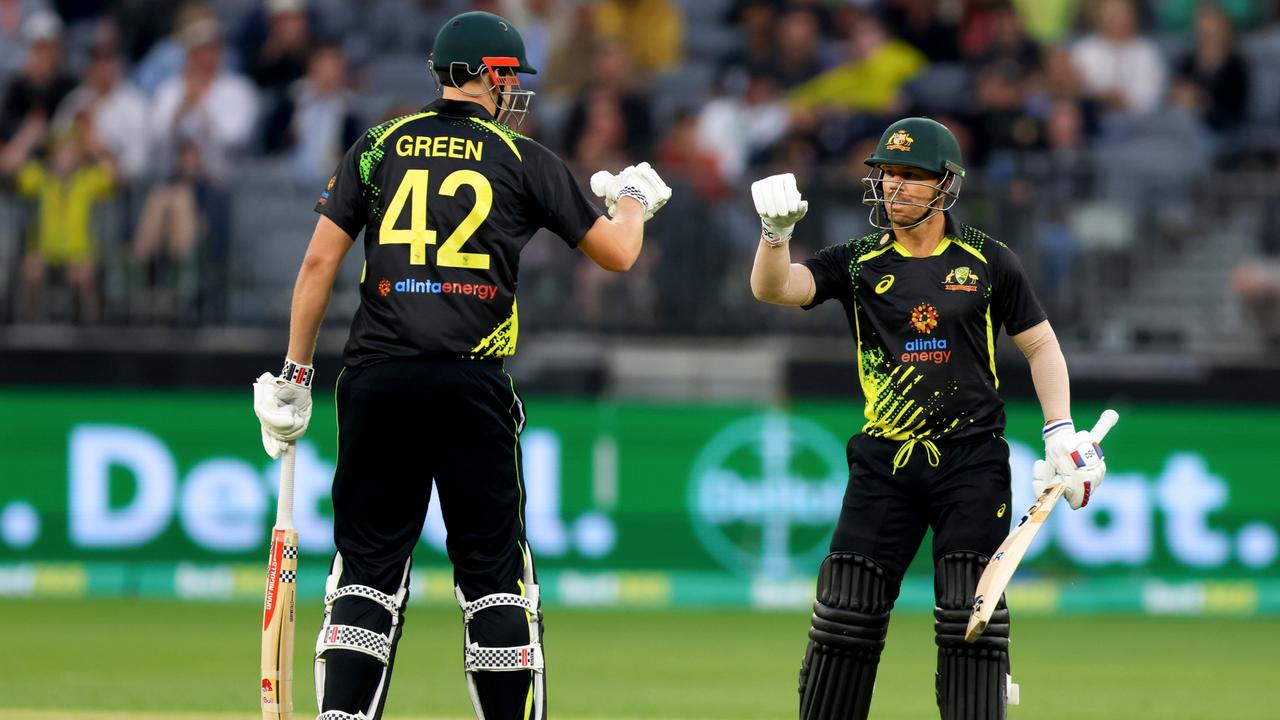 PERTH, AUSTRALIA - OCTOBER 09: David Warner of Australia and Cameron Green of Australia fist bump after their over during game one of the T20 International series between Australia and England at Optus Stadium on October 09, 2022 in Perth, Australia. (Photo by James Worsfold/Getty Images)