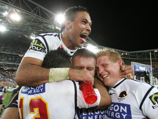 Hannant celebrates with teammates after Brisbane’s 2006 NRL grand final win.