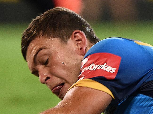 Titans player Ashley Taylor crosses over to score during the Round 3 NRL match between the Gold Coast Titans and the West Tigers at CBUS Stadium on the Gold Coast, Saturday, March 19, 2016. (AAP Image/Dave Hunt) NO ARCHIVING, EDITORIAL USE ONLY