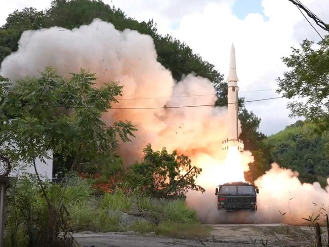 Chinese forces launch a test missile into the water off the coast of Taiwan. Picture: Reuters