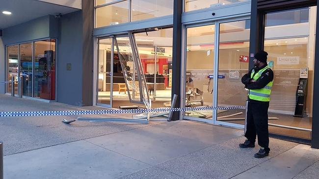 A security guard watches on after a ram raid in Lynbrook