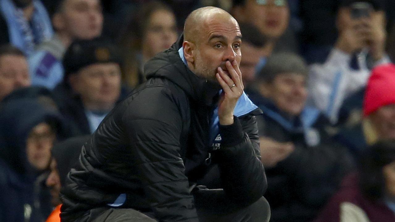 Manchester City's head coach Pep Guardiola reacts after a missed chance to score during the match between Manchester City and Manchester United