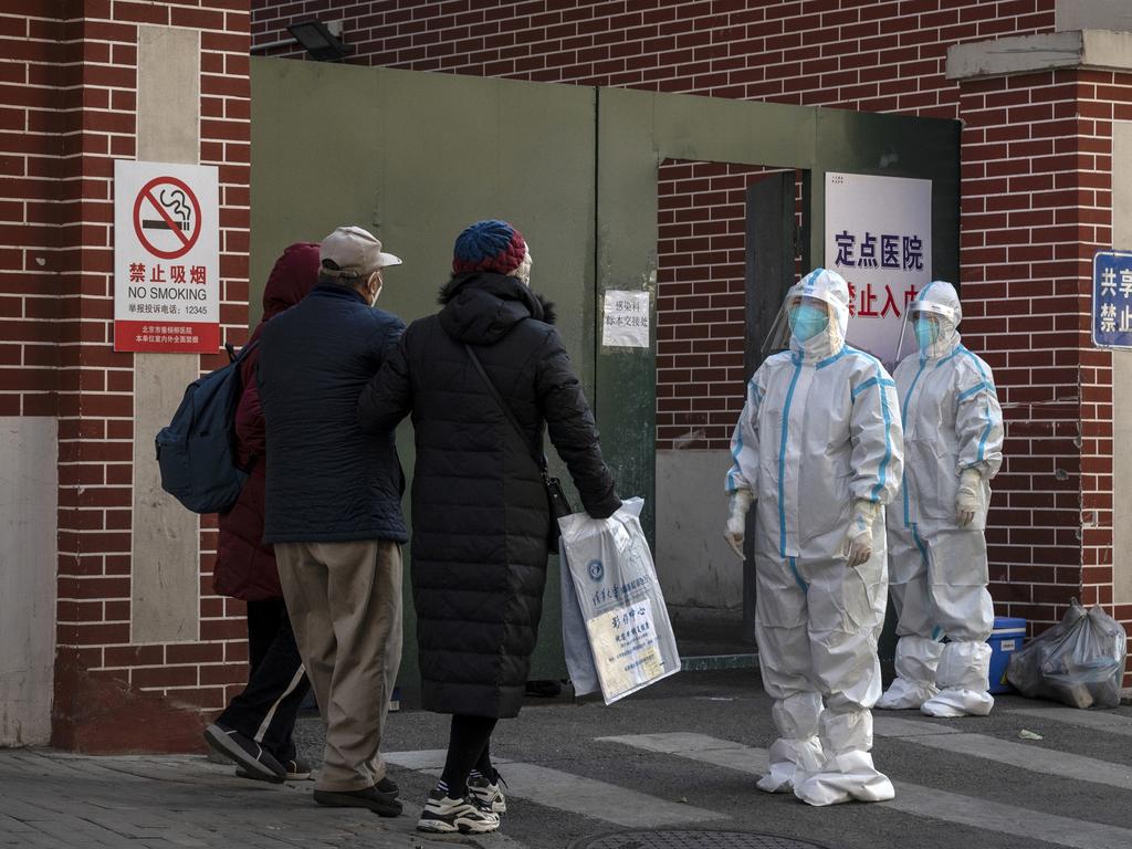 Medical staff wear PPE as they wait to assist patients at a fever clinic treating Covid patients in Beijing. Picture: AFP