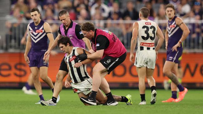 Lachie Schultz of the Magpies leaves the field injured. Photo by Janelle St Pierre/AFL Photos via Getty Images.