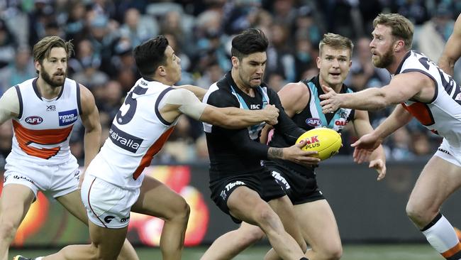 Power’s Chad Wingard tries to dispose of the ball under pressure from Dylan Shiel. Picture SARAH REED