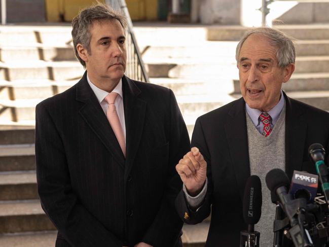 Former Trump lttorney Michael Cohen (L) looks on as his lawyer speaks to members of the media outside the district attorney's office in New York City. Picture: AFP