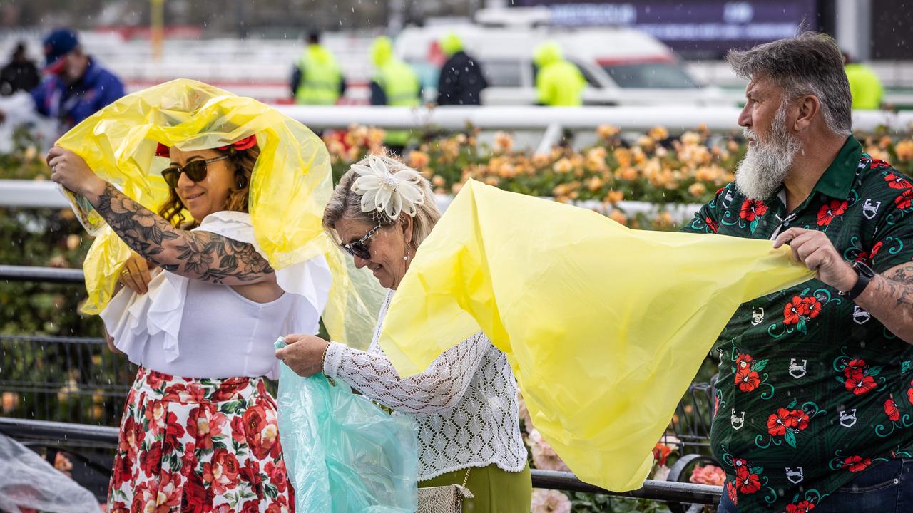 Melbourne Cup. 2022. People prepare for rain. Picture: Jake Nowakowski