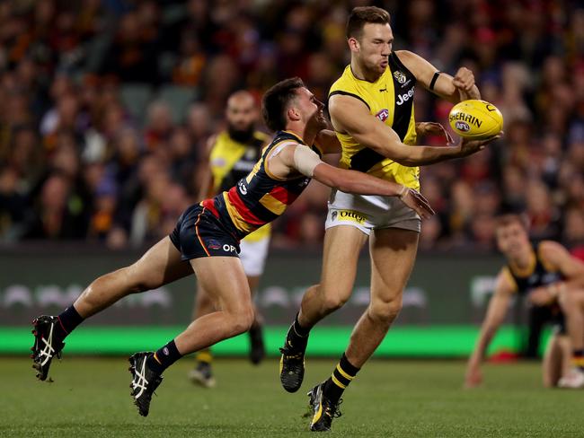 Lachlan Murphy tackles Nathan Broad during the first quarter at Adelaide Oval on Friday night before leaving the field. Picture: James Elsby/AFL Photos via Getty Images