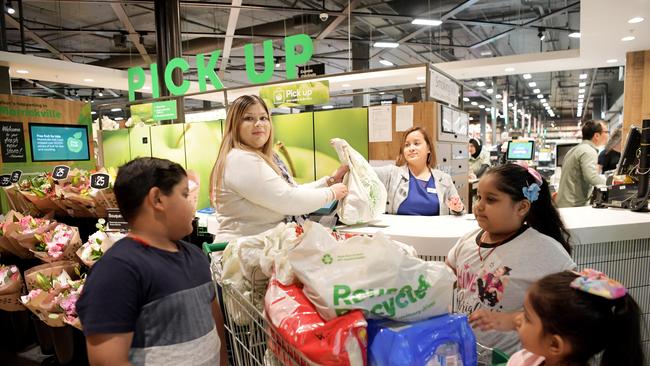 Mother-of-three Anne Prasad collects her online grocery shopping from a Woolworths store with her children. Picture: Tracey Nearmy