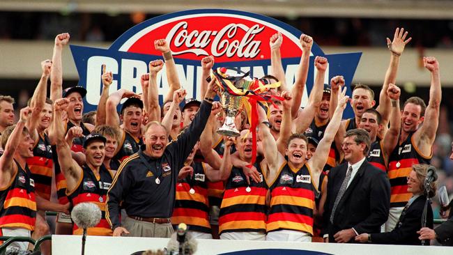 Malcolm Blight and Mark Bickley hold the 1998 AFL premiership trophy.