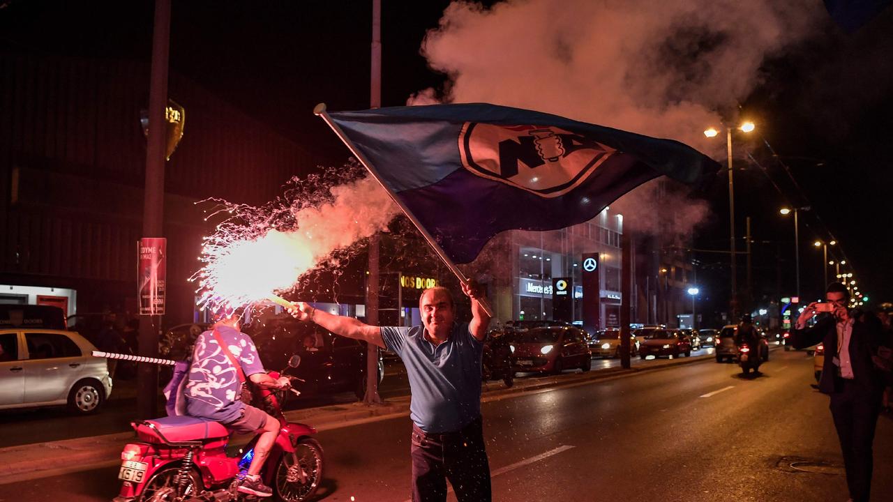 Supporters of the Greece's newly elected Prime Minister celebrate outside the party's headquarters. Picture: AFP