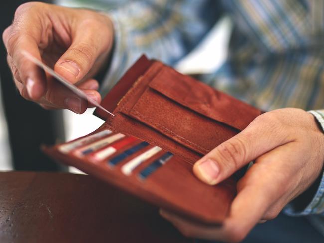 Man buys with a credit card. Generic photo of a wallet, credit cards, paying with credit card. Picture: Mixetto/ Istock