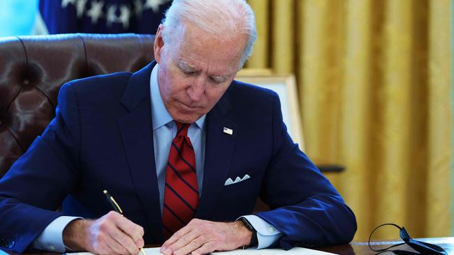 Executive decision: US President Joe Biden doodles some mean pictures of Donald Trump. Picture: AFP