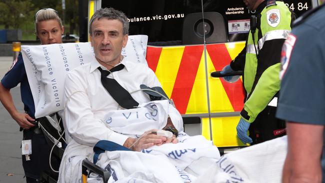 Dover responsible manager and owner Terry McMaster leaves the Federal Court with the aid of paramedics after collapsing while being questioned during the Banking Royal Commission in Melbourne, Thursday, April 26, 2018. The head of a financial advice firm has collapsed in the stand at the banking royal commission after begin accused of lying. (AAP Image/Stefan Postles) NO ARCHIVING