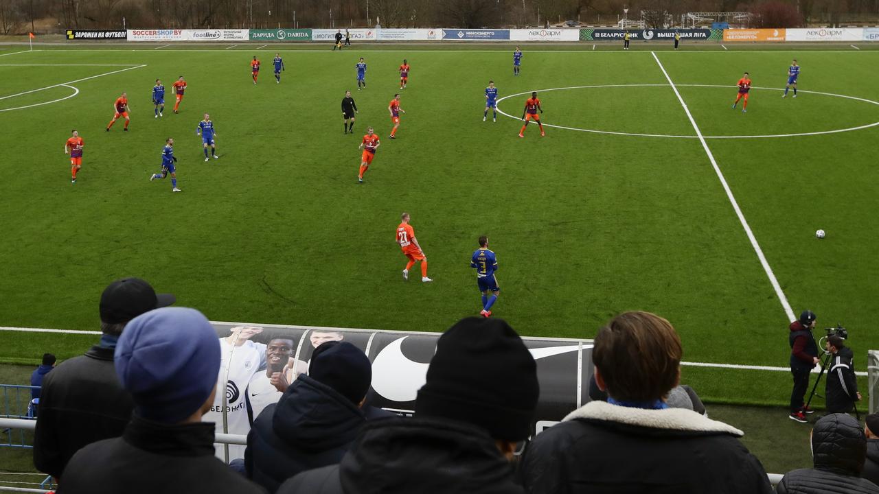 Football fans watch the Belarus Championship soccer match between Energetik-BGU and Bate in Minsk, Belarus.