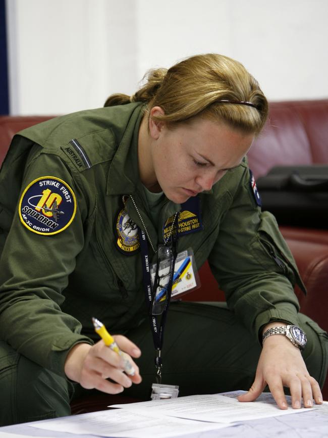 Then Flying Officer Melissa Houston, a navigator with Crew 3 of 10 Squadron, carries out her pre-flight planning ahead of air, ground and naval forces from Singapore, Malaysia, New Zealand and the UK in the South China Sea in 2009.