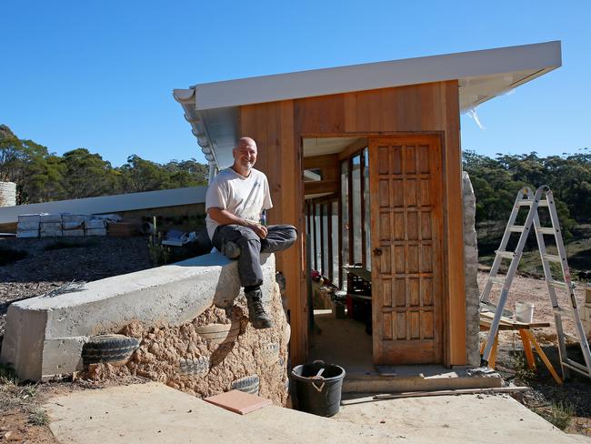 SATURDAY TELEGRAPH - Mark Van Laarhoven is building a house using materials like used car tyres and empty beer bottles on his property near Marulan. When finished the house won't require heating or cooling and will run off solar power. Picture: Toby Zerna