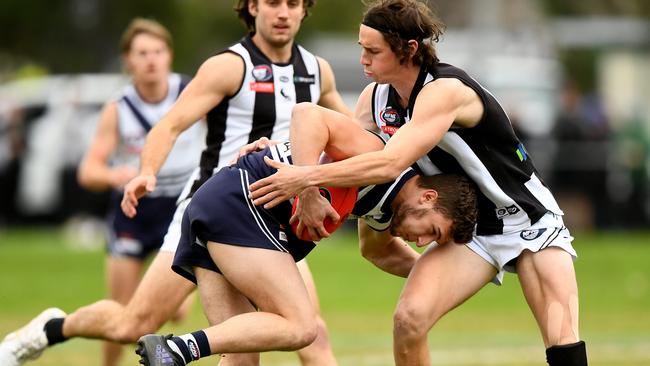 Bundoora’s James Sekulovski is tackled by Marcus Lentini of Montmorency. Picture: Josh Chadwick