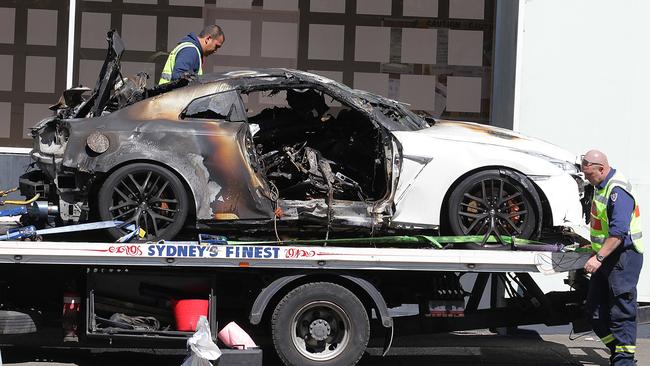 The burnt-out car is taken from the scene of a fatal car crash on Harbour Street, Darling Harbour. Picture: Danny Aarons