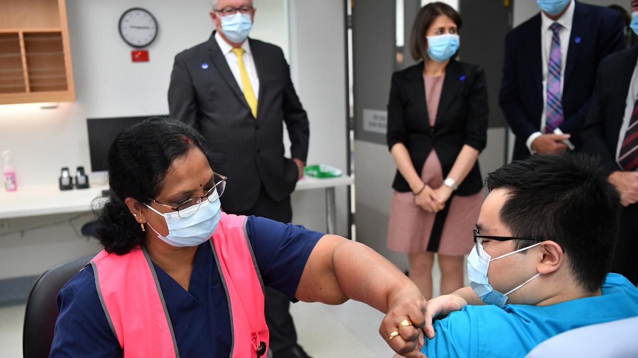 NSW Premier Gladys Berejiklian and Health Minister Brad Hazzard look on as NSW Health worker Andrew Santoso receives his COVID-19 vaccination in Sydney. Picture: Dean Lewins/AAP