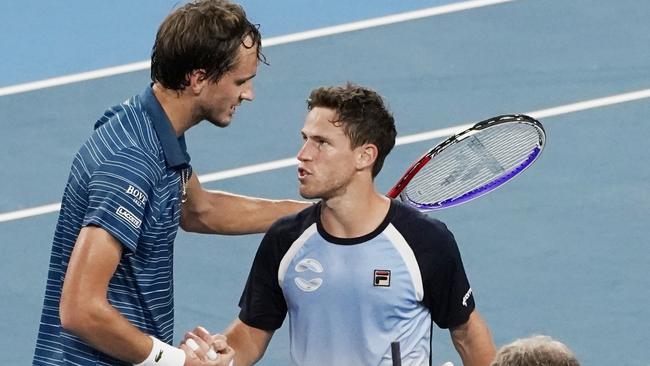 Daniil Medvedev and Diego Schwartzman exchange words at the net. Picture: AAP Images