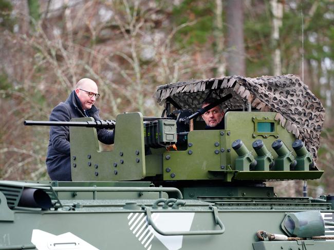 King Frederik X (R) of Denmark hears about the features of the Patria 6x6 vehicle as he visits the main base of the Coastal Brigade in Upinniemi, Kirkkonummi, Finland. Picture: AFP / Denmark OUT