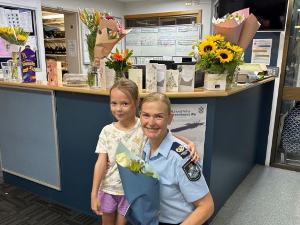 Officer in Charge of the Hervey Bay Police Station, Senior Sergeant Brooke Flood with a young local supporter who wanted to give officers a hug.