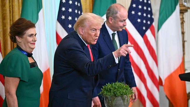 US President Donald Trump flanked by Irish Prime Minister Micheal Martin and his wife Mary a St Patrick’s Day reception this week. Picture: AFP