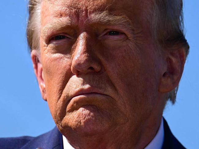 TOPSHOT - Former US President and Republican presidential candidate Donald Trump speaks to the media in Swannanoa, North Carolina, on October 21, 2024, after observing cleanup efforts in the aftermath of Hurricane Helene, which devastated the region. (Photo by Jim WATSON / AFP)