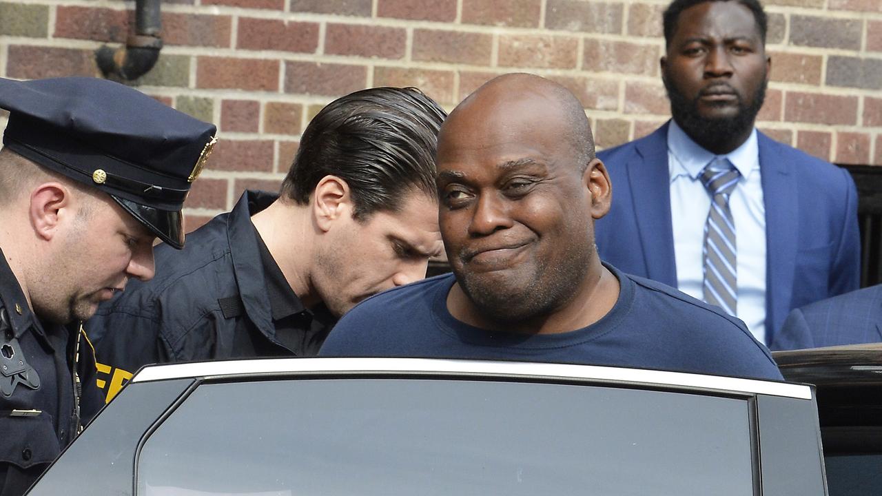 Frank James smirked as he was led out of a police station on Wednesday. Picture: Matthew McDermott