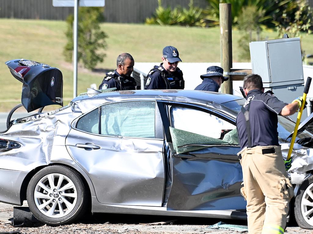 Police inspecting one of the vehicles involved in the Murrumba Downs crash. The Audi allegedly struck a stationary sedan – an unmarked police car – after the fatal crash involving the white Corolla. Picture: John Gass