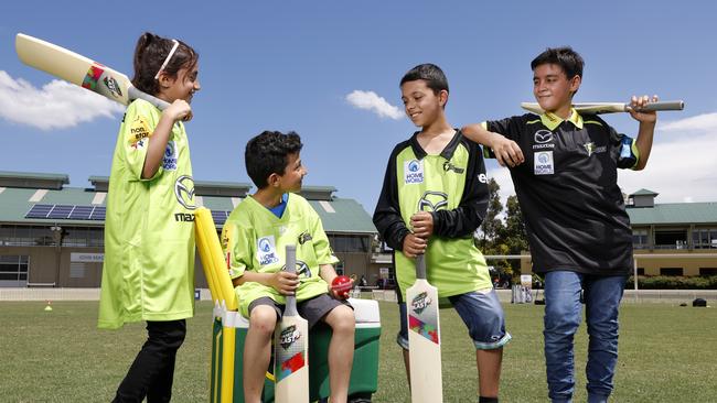 Youngsters enjoy their new cricket gear following the launch of The Welcome Project. Picture: Jonathan Ng