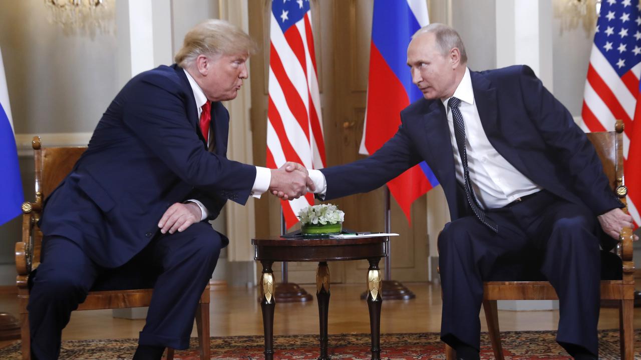 Mr Trump shakes hands with Mr Putin. Picture: Pablo Martinez Monsivais/AP