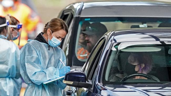 Medical workers test people in a drive-through COVID-19 pop-up clinic in Melbourne. Picture: AAP