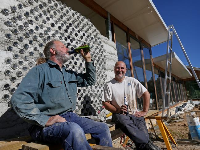 Mark gets some 'help' drinking beers to use the empty bottles from friend Kris Allen. Picture: Toby Zerna