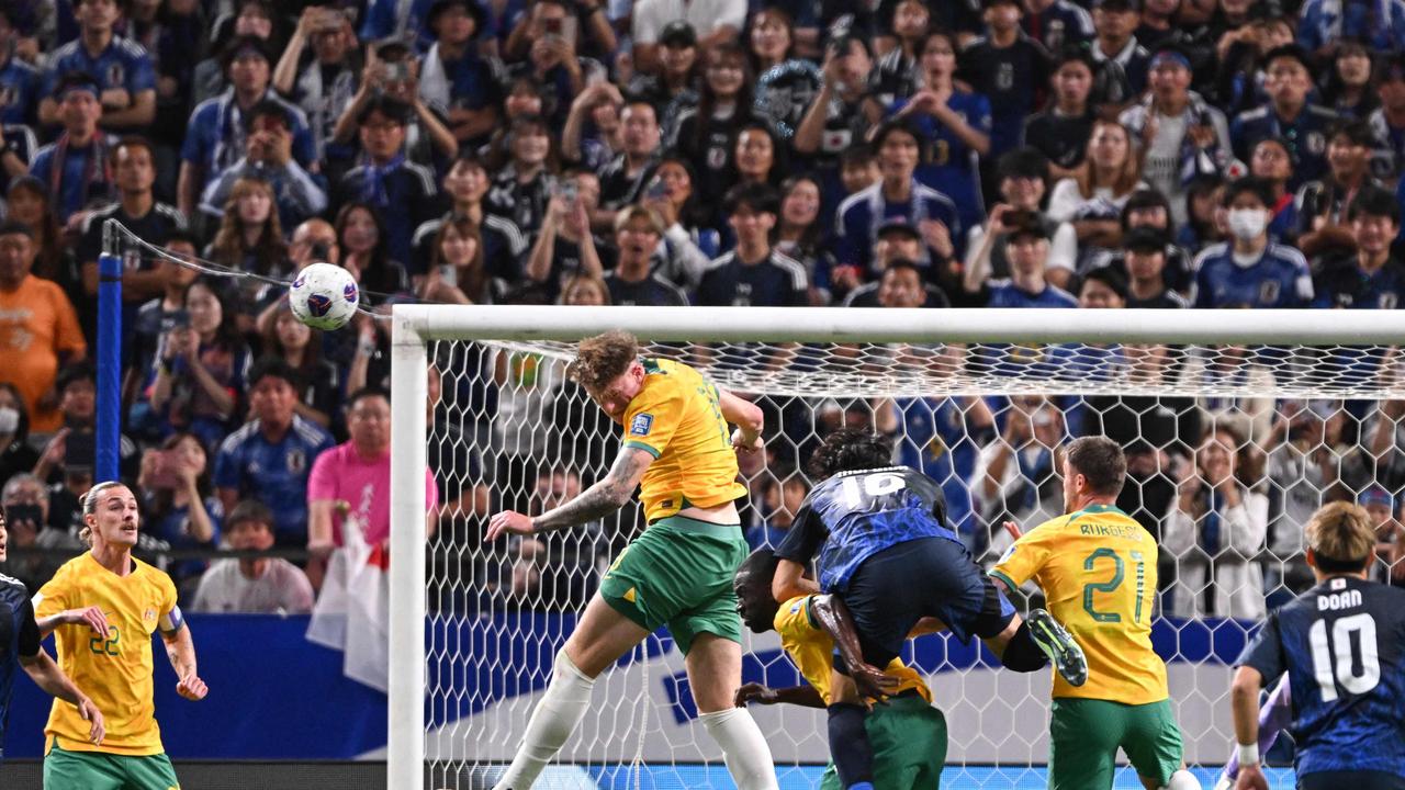 Socceroos digging in against relentless Japan attack