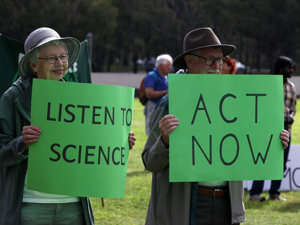 People hold signs at the rally. Picture: NCA NewsWire/Gary Ramage