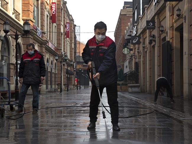 Cleaners wash a street in Wuhan, Hubei province, China. Picture: GETTY IMAGES