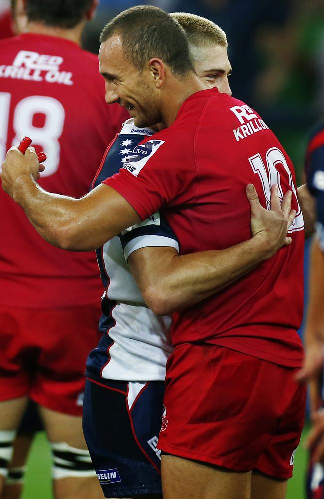 Two of the three amigos embrace after playing each other in a Super Rugby game last year.