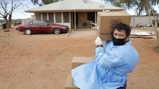 Volunteer Brendan Adams delivers food parcels in Wilcannia a week ago. Picture: Chris Pavlich